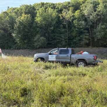 Field crew working beside the riprap embankment at the Hopkinton–Everett project in New Hampshire.