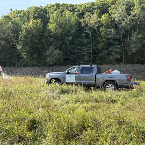 Field crew working beside the riprap embankment at the Hopkinton–Everett project in New Hampshire.