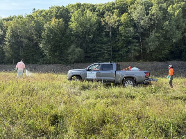 Field crew working beside the riprap embankment at the Hopkinton–Everett project in New Hampshire.