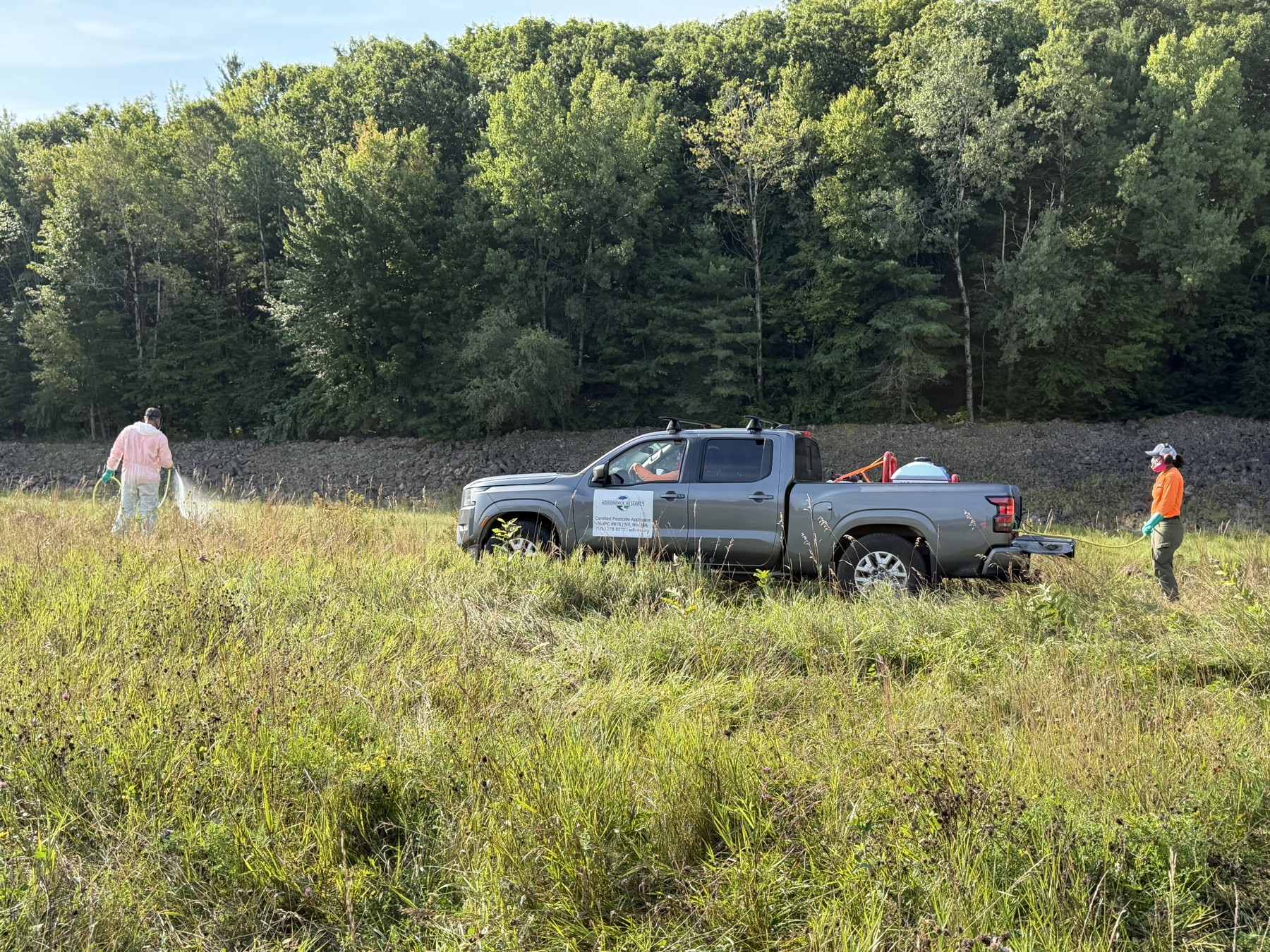 Field crew working beside the embankment at Hopkinton–Everett.
