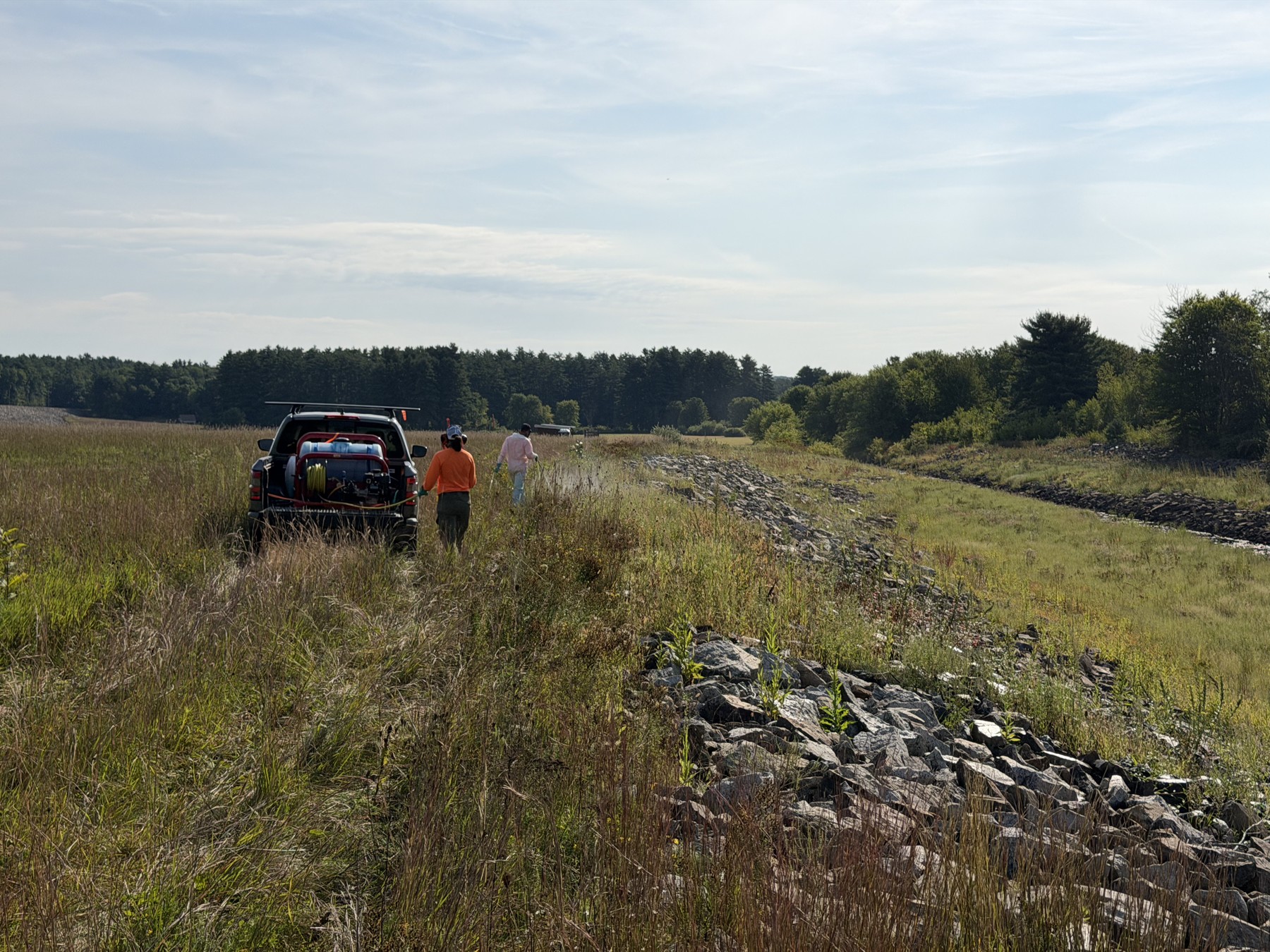 Field crew and work vehicle beside the embankment at Hopkinton–Everett.