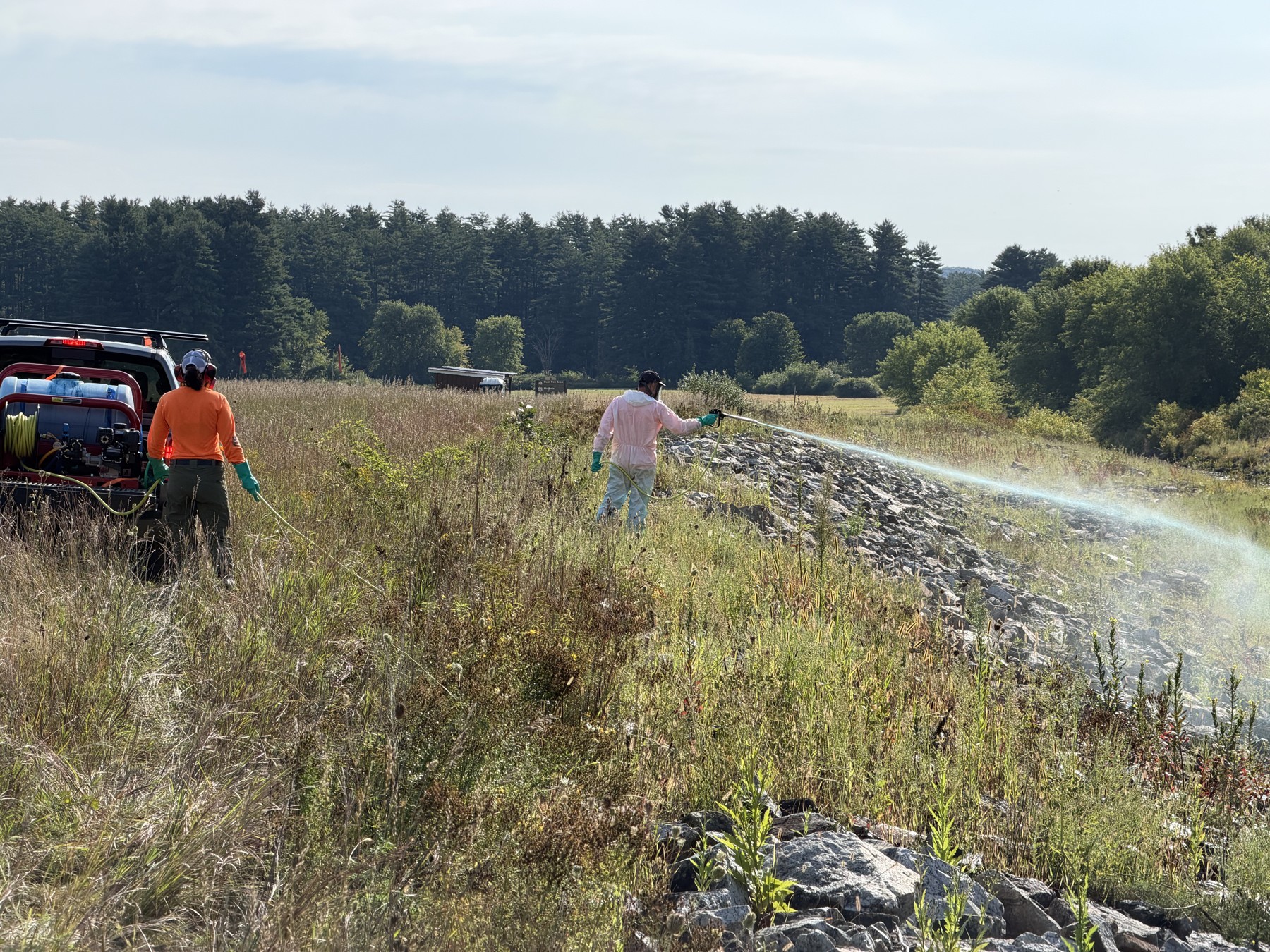 Crew members working alongside the riprap embankment at Hopkinton–Everett.